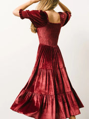 Burgundy velvet midi dress with smocked bodice and ruffled short sleeves.