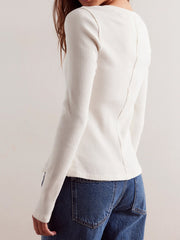 White ribbed knit button-front slim fit top with long sleeves and a seam detail down the back.