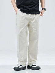 Beige casual straight leg trousers with a loose fit, worn by a man.