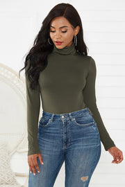 Army green turtleneck bodysuit with long sleeves, paired with distressed denim jeans.