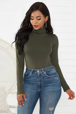 Army green turtleneck bodysuit with long sleeves, paired with distressed denim jeans.