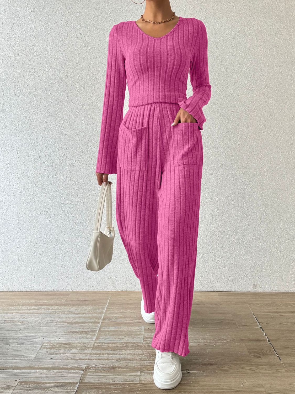 Hot Pink ribbed knit loungewear set with V-neck top and flared pants with pockets.