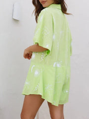 Light Green celestial print linen romper with short sleeves and buttoned collar.