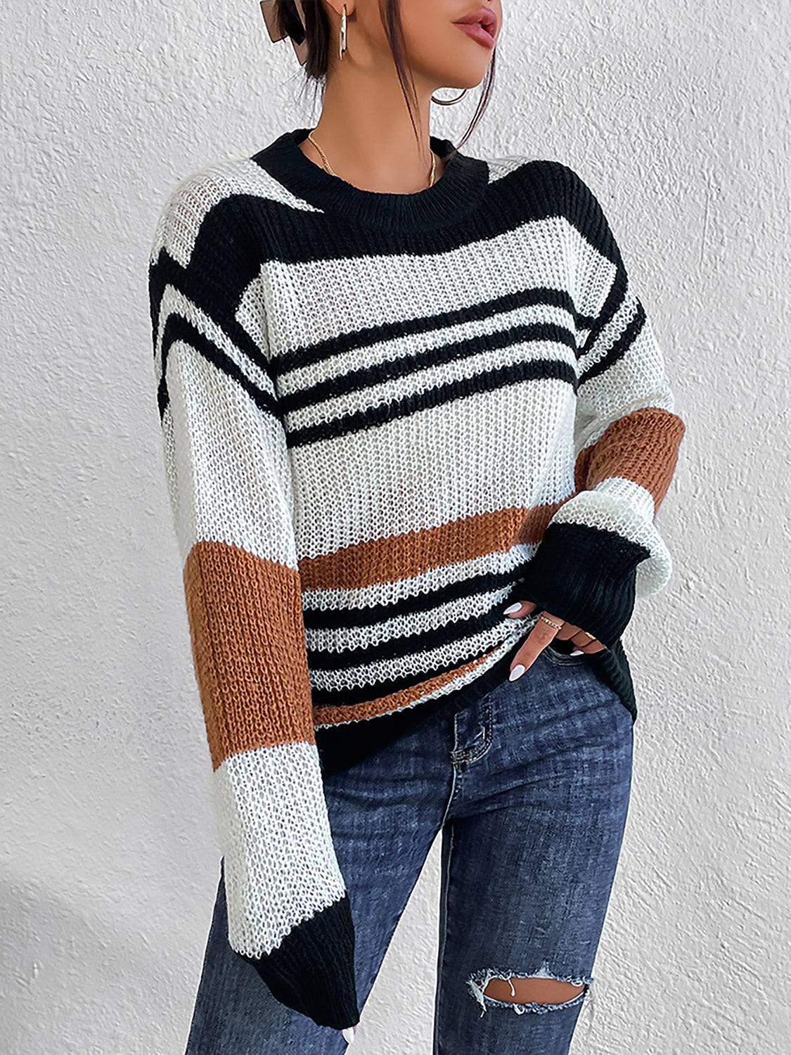 Colorblock stripe knit crewneck sweater in acrylic with black, white, and caramel stripes.