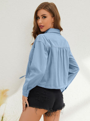 Light blue denim cropped drawstring shirt with buttoned cuffs and a collared neckline.