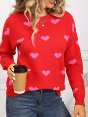 Red acrylic knit sweater with pink hearts, crew neck, long sleeves.