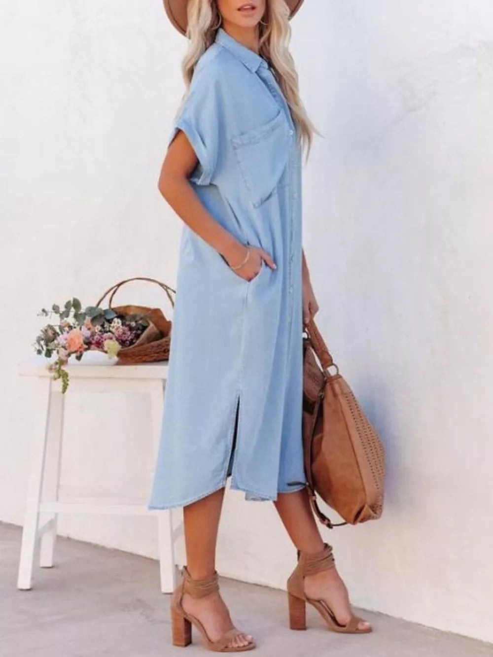 Light blue denim midi shirt dress with short sleeves, button front, pockets, and side slits.
