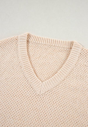 Beige open-knit V-neck sweater with ribbed trim and a slouchy fit.