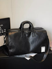 Black pu leather travel bag with top handles and adjustable shoulder strap