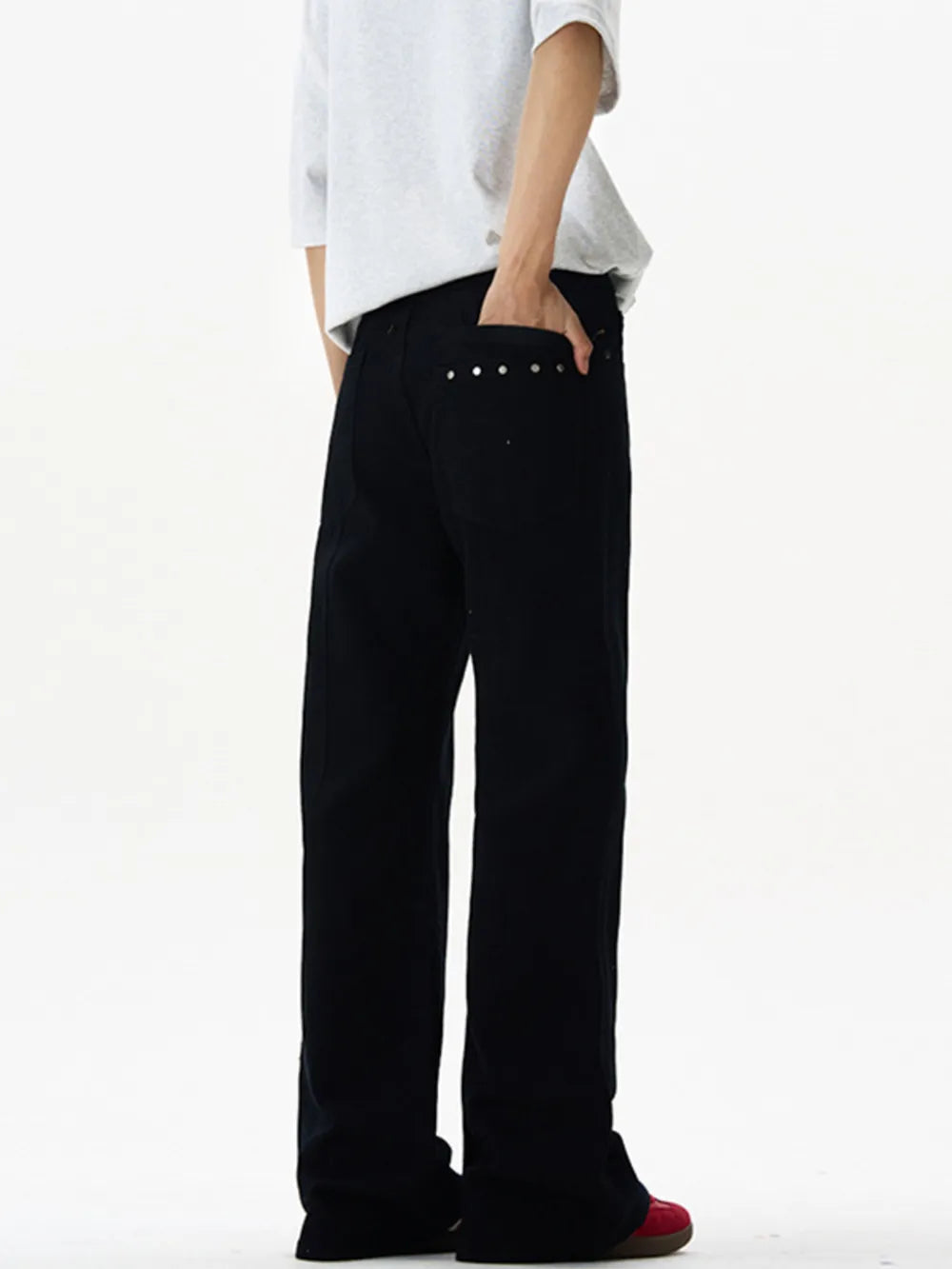 Black wide-leg sweatpants with studded back pockets and a relaxed fit.