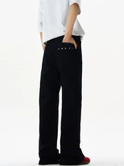 Black wide-leg sweatpants with studded back pockets and a relaxed fit.