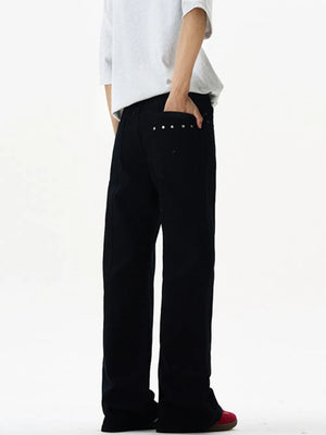 Black wide-leg sweatpants with studded back pockets and a relaxed fit.