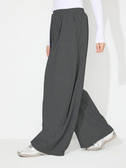 Dark Gray pleated drape palazzo trousers with a wide leg and elastic waistband.