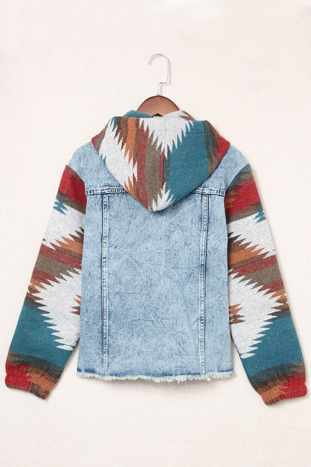 Light blue denim hoodie jacket with Southwestern print sleeves and hood, raw hem
