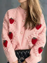 Pink knit cardigan with strawberry appliques and pearl buttons.
