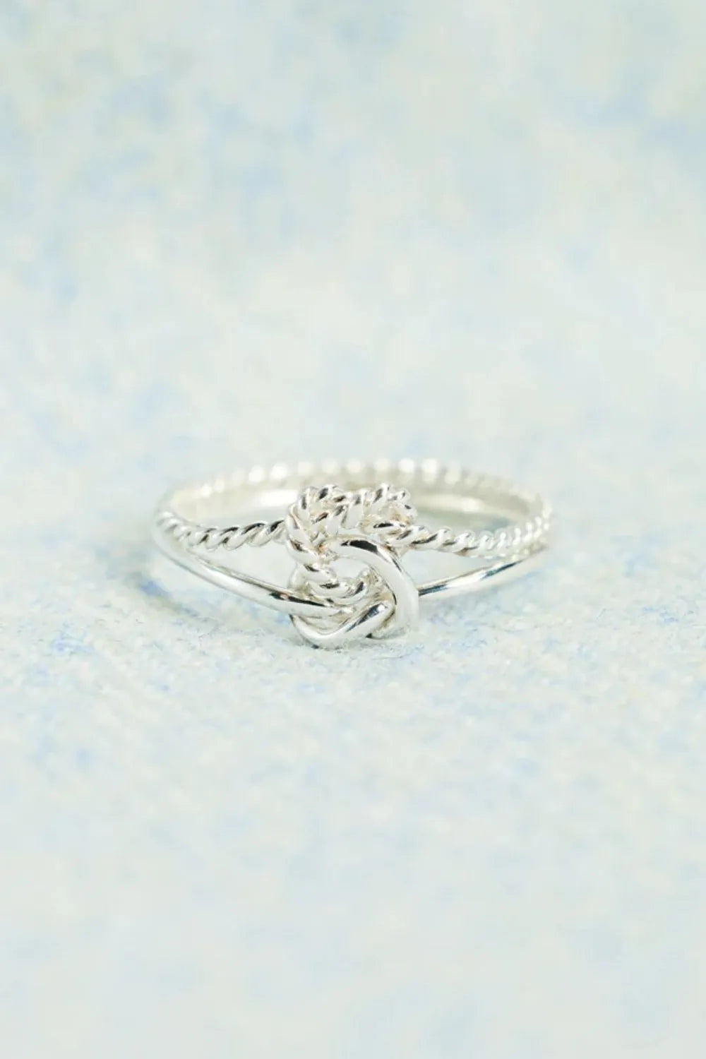 Silver rope knot ring in 925 sterling silver with a twisted band detail.