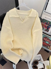 Apricot textured knit polo collar sweater with V-neck and long sleeves.