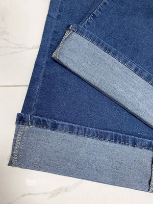 Medium wash wide-leg denim jeans with a contrast cuff detail.