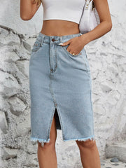 Light blue denim pencil skirt with front slit and frayed hem.
