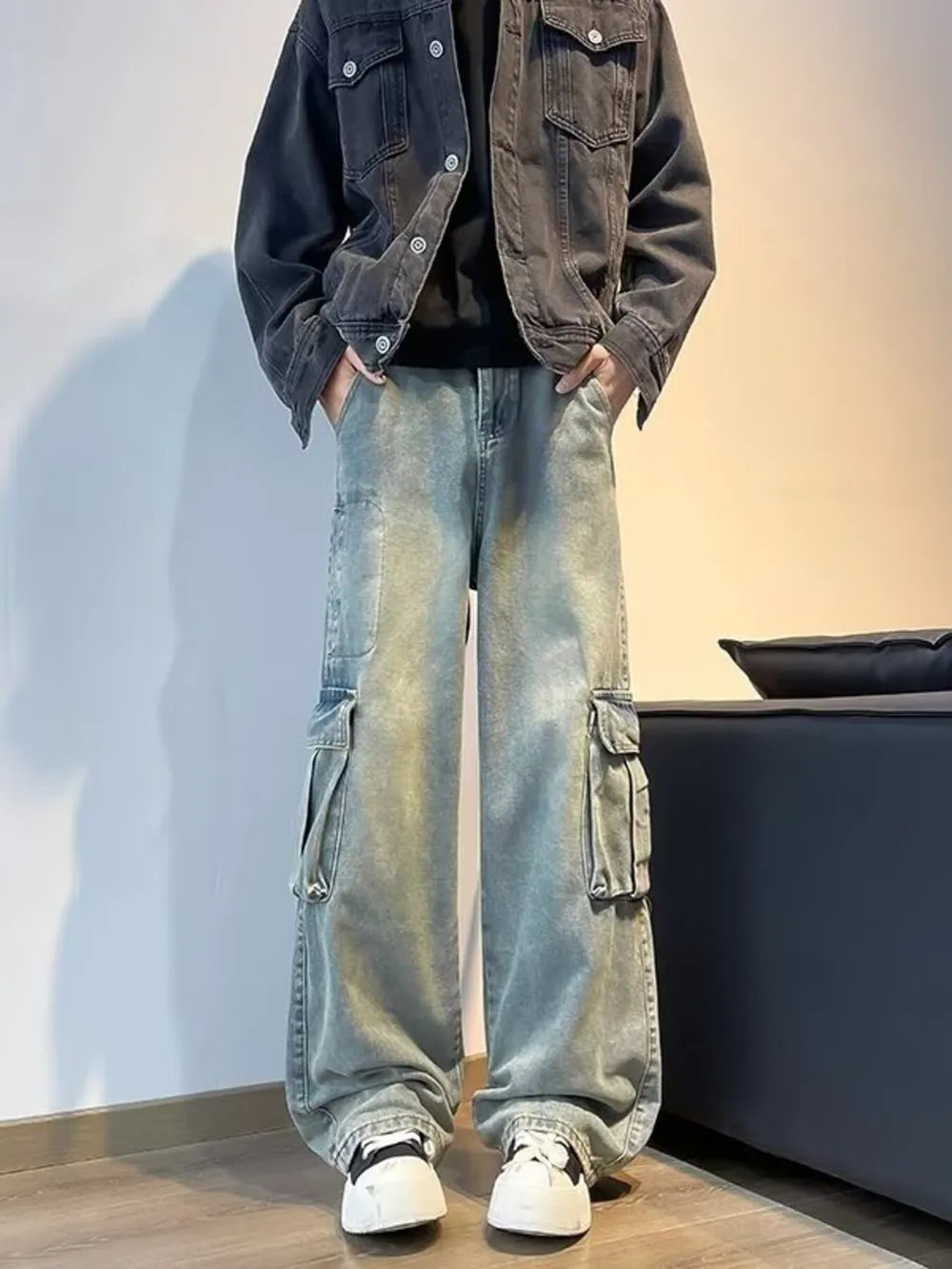 Vintage wash oversized wide-leg cargo jeans with distressed details and ankle pooling.