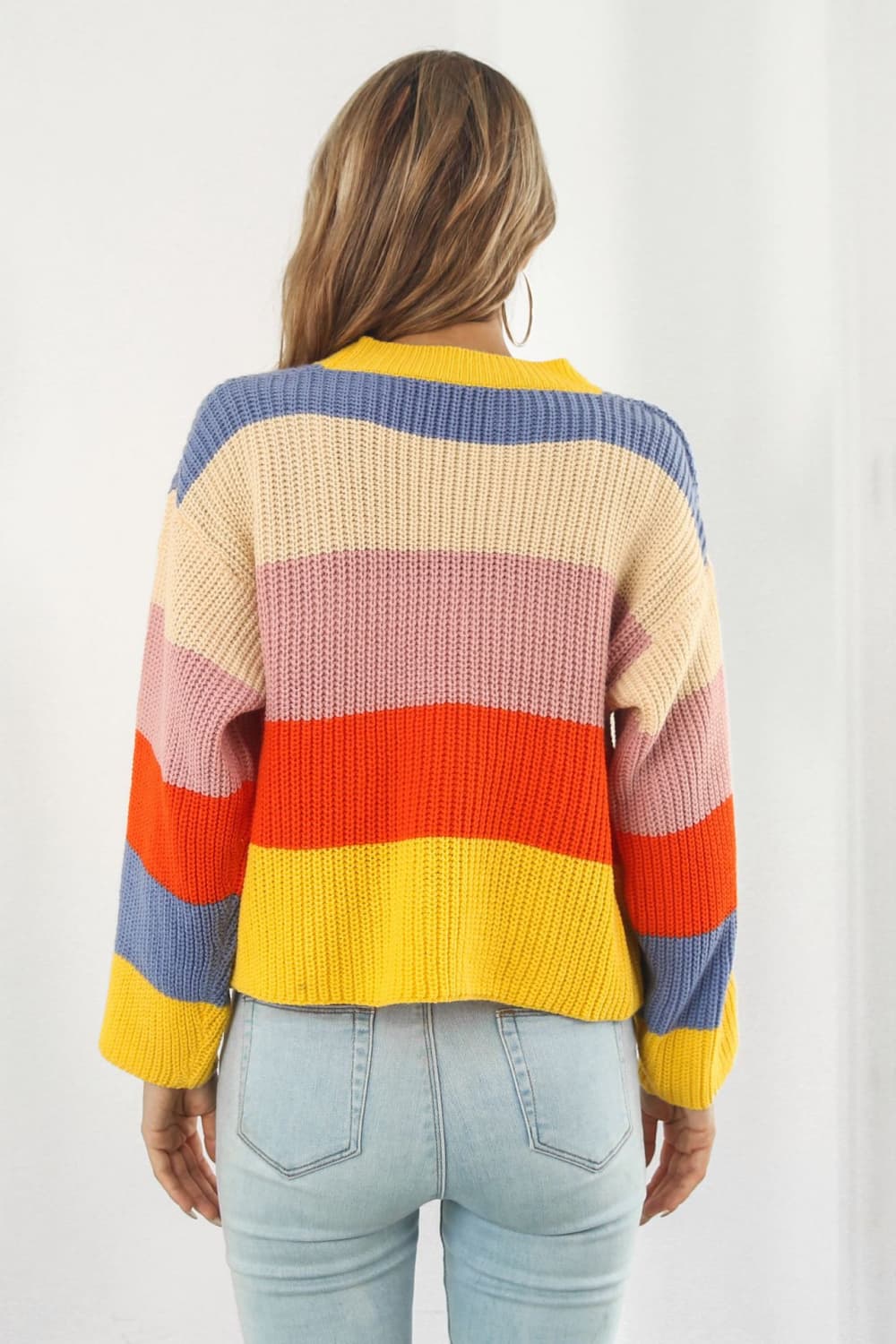Rainbow block stripe knit cardigan with yellow, blue, pink, and orange stripes.