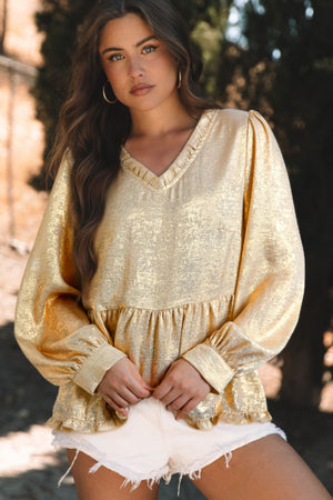 Metallic gold blouse with gathered sleeves, v-neck, and ruffled hem.