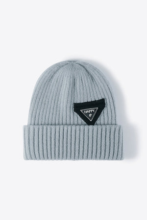 Steel ribbed acrylic beanie with a black triangle patch with "HAPPY" text.