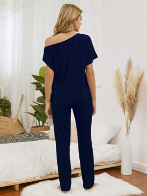 Dark blue loungewear set with asymmetric neckline and straight leg pants.