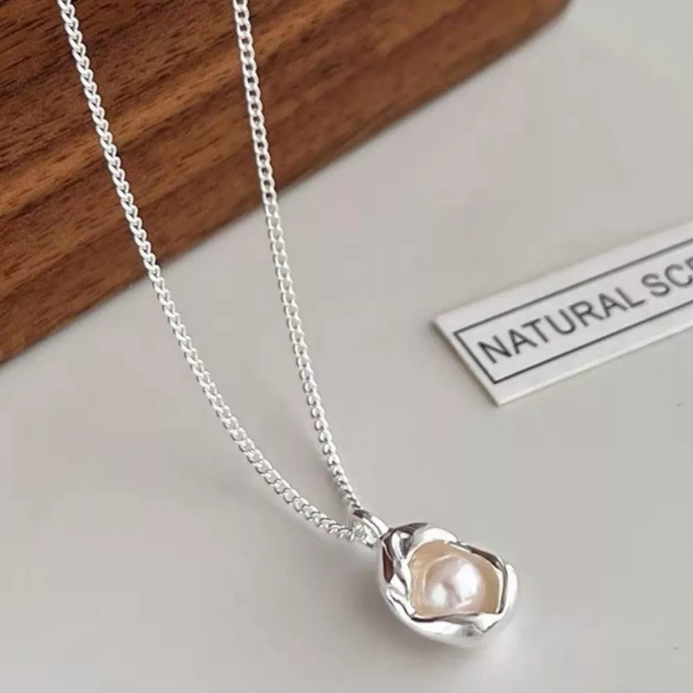 Sterling silver necklace with a lustrous freshwater pearl pendant.