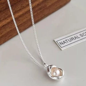 Sterling silver necklace with a lustrous freshwater pearl pendant.