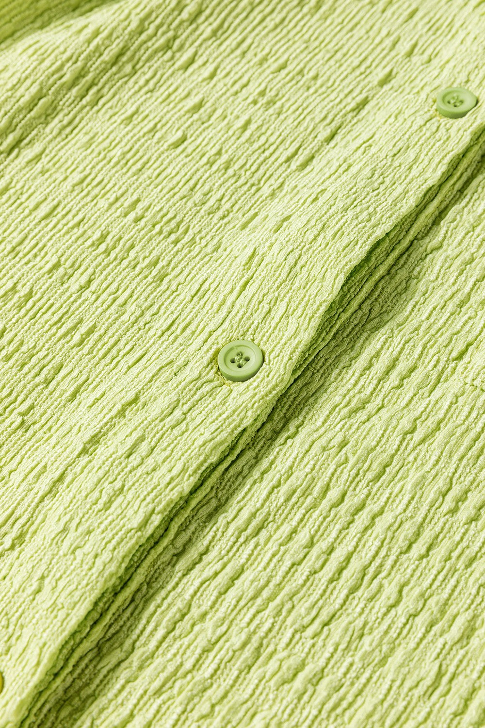 Lime textured collared romper with button detail and patch pocket close-up