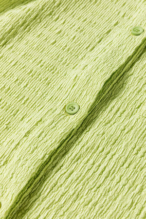 Lime textured collared romper with button detail and patch pocket close-up