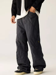 Relaxed fit cargo sweatpants for men in dark gray cotton with multiple pockets and stitching details.