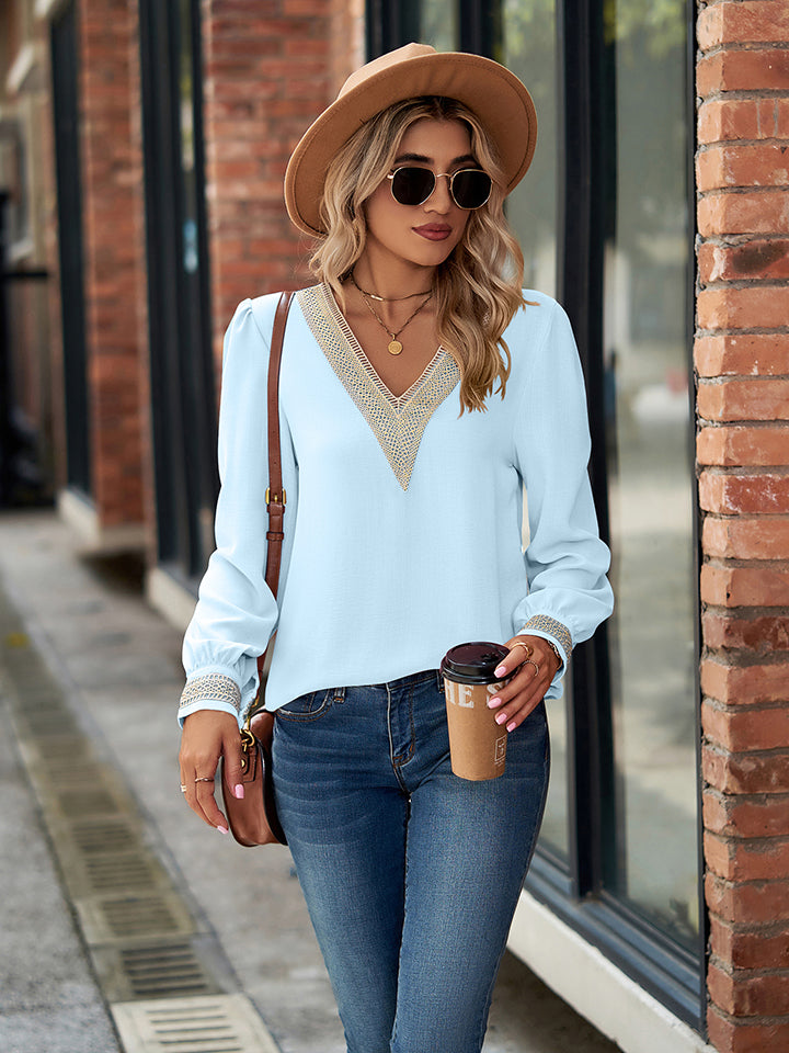 Pastel blue blouson sleeve top with embroidered trim neckline and cuffs