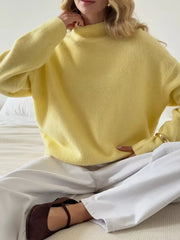 Relaxed mock neck knit sweater in pastel yellow, acrylic blend, with long sleeves.