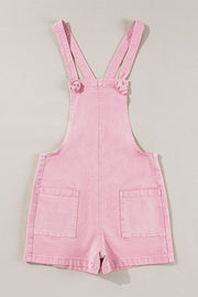 Blush pink denim short overalls with knotted straps and patch pockets.