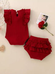 Red ribbed baby romper with ruffle sleeves and matching tiered ruffle bloomers.