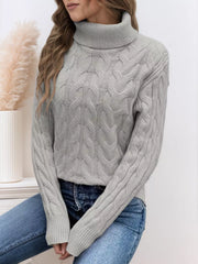 Grey cable-knit turtleneck sweater with ribbed cuffs and collar.