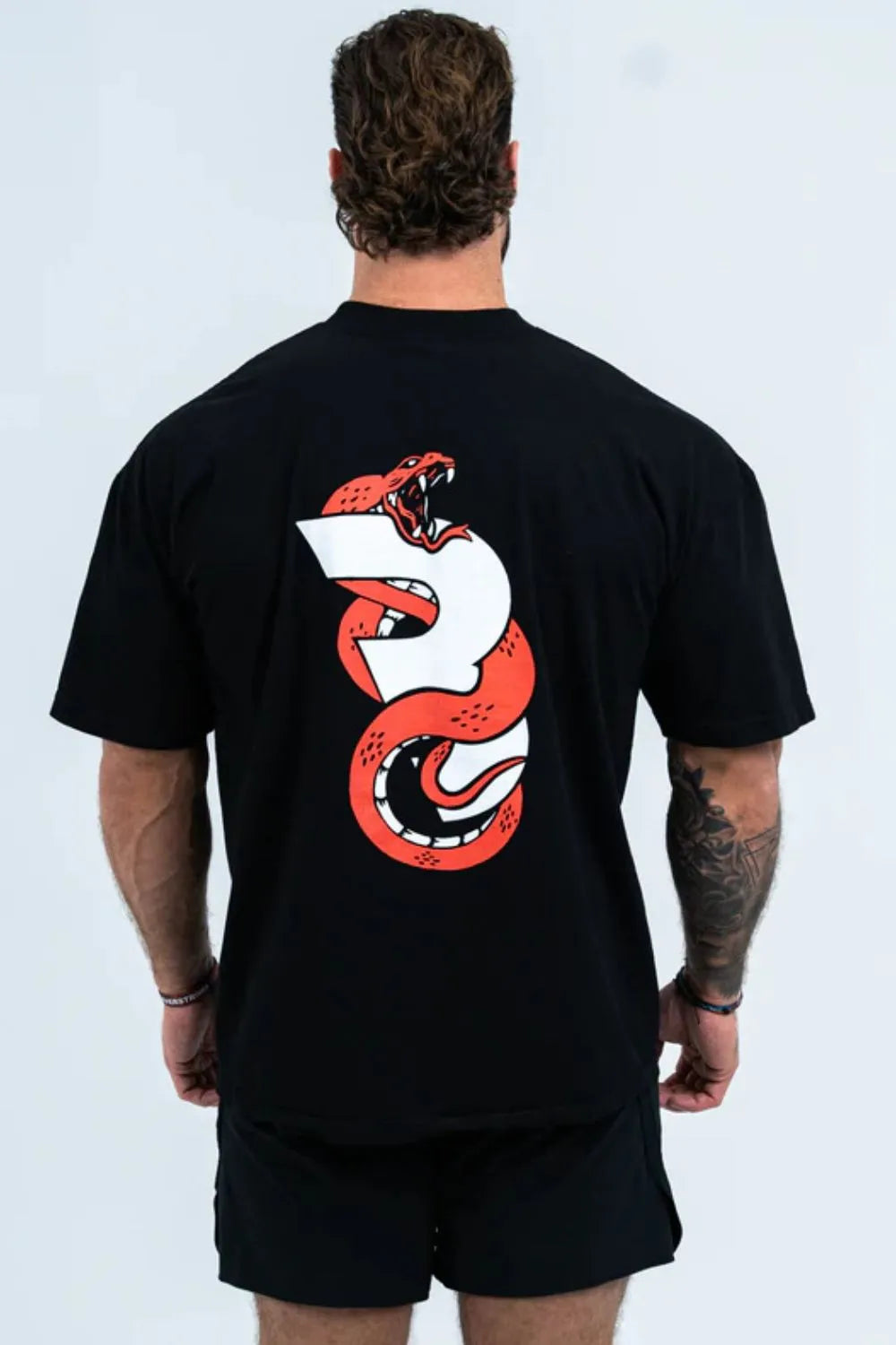 Black oversized graphic tee with a red snake design on the back.