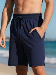 Navy blue chino shorts for men with drawstring and textured pattern.