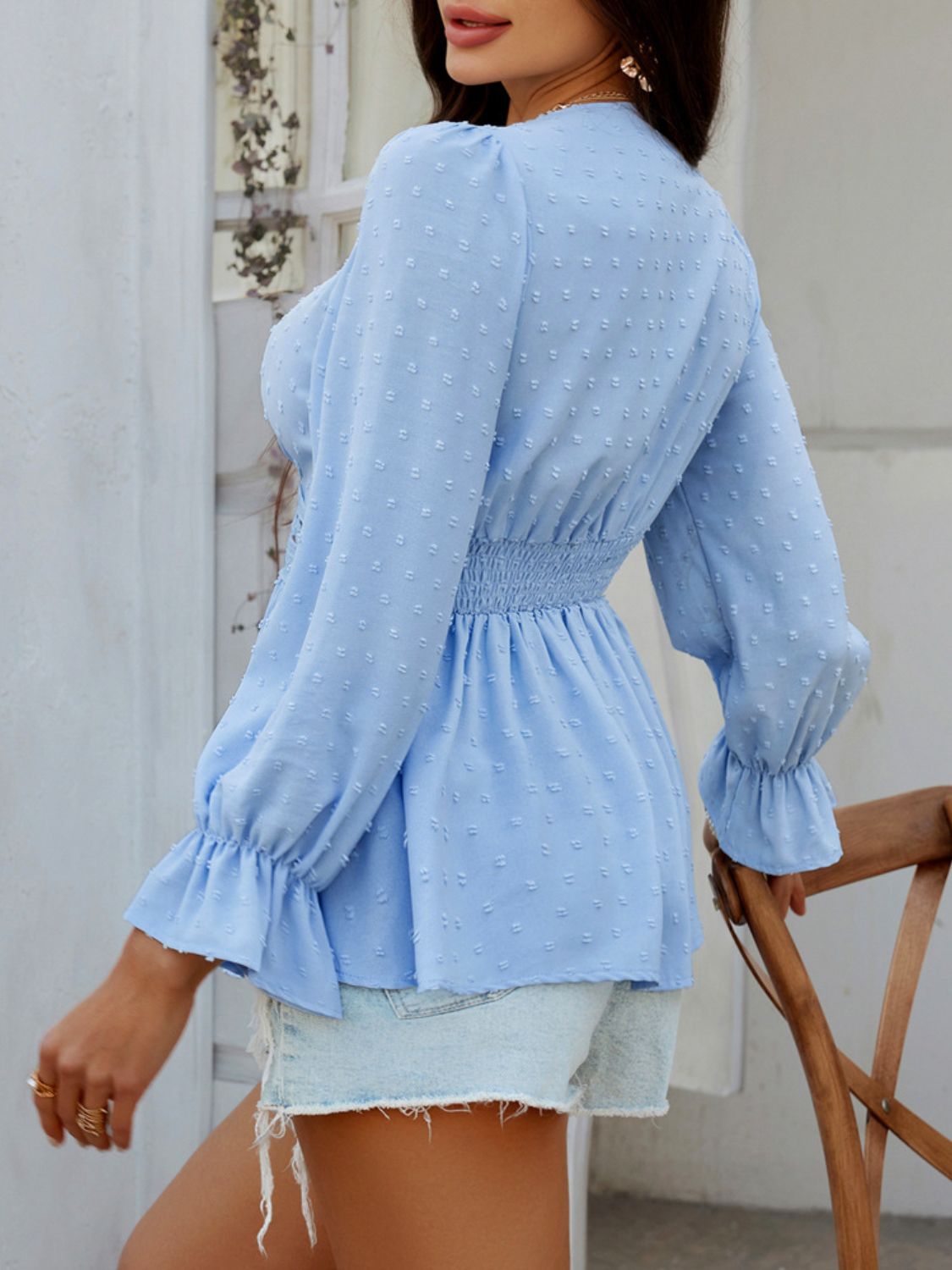 Light blue Swiss dot blouse with smocked waist and ruffled cuffs.