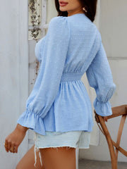 Light blue Swiss dot blouse with smocked waist and ruffled cuffs.
