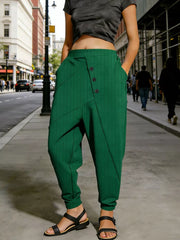 Green harem pants with decorative buttons and pockets, cuffed ankles
