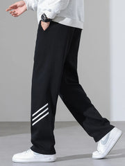 Black sweatpants with white stripes on the leg, loose fit, casual athleisure style.
