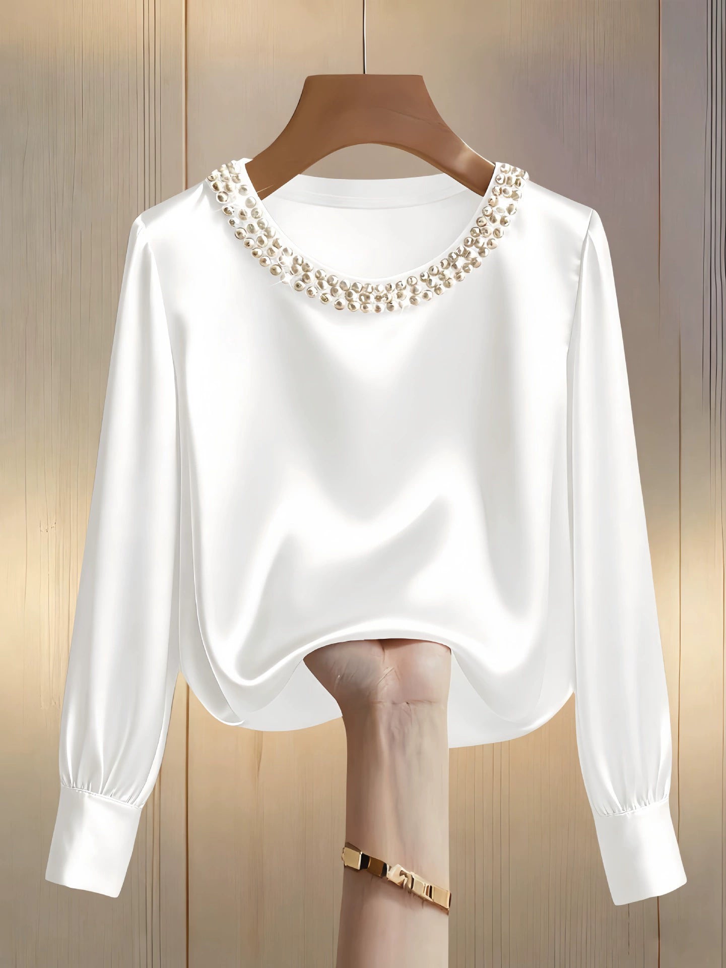 White satin blouse with pearl trim round neckline and long sleeves.