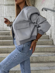 Gray faux leather bomber jacket with sculpted sleeves and chest pockets.