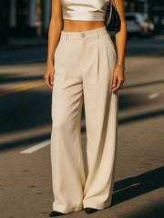 Cream high-waisted pleated maternity trousers with a button closure and wide leg.