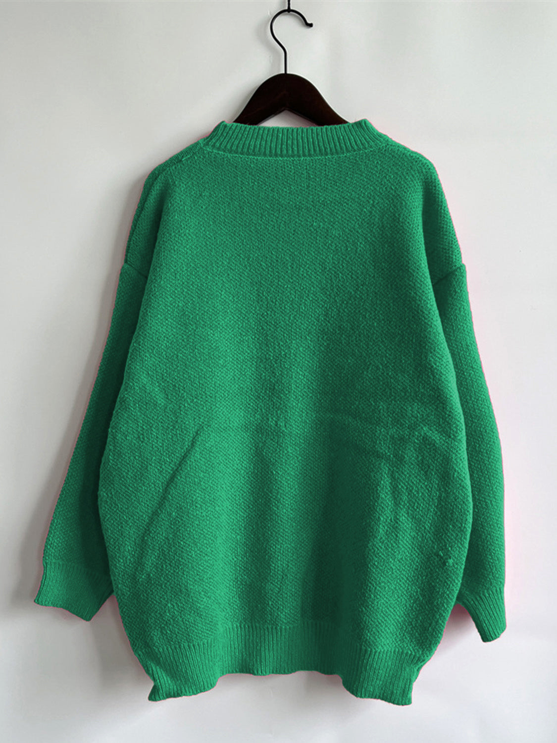 Green knit jumper with crew neck and ribbed cuffs and hem.