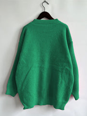Green knit jumper with crew neck and ribbed cuffs and hem.