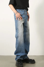 Vintage wash baggy denim jeans in medium blue, featuring a faded effect and relaxed fit.